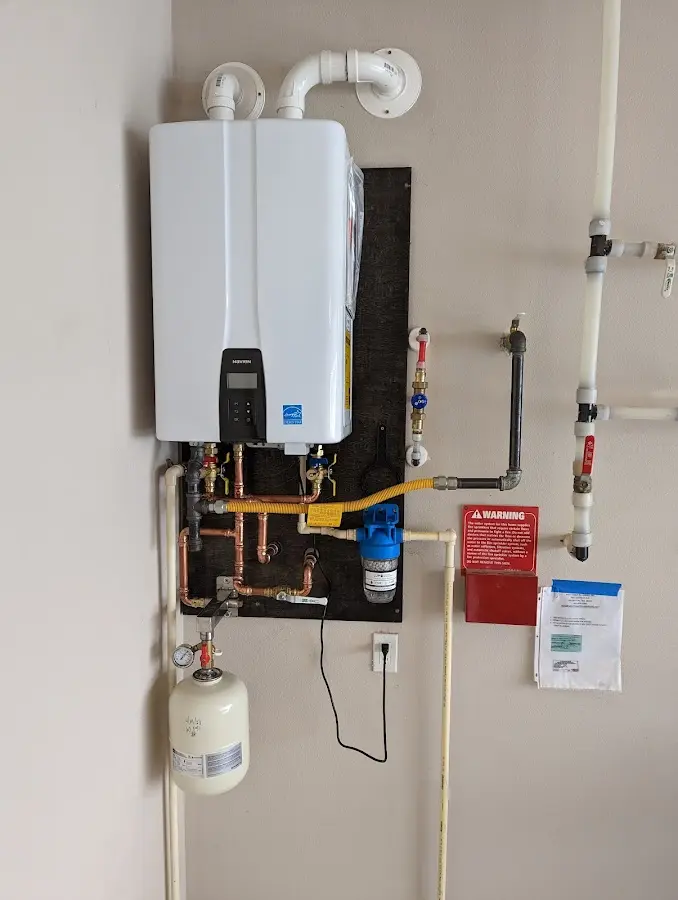 Professional plumber installing copper piping in a Garden City home